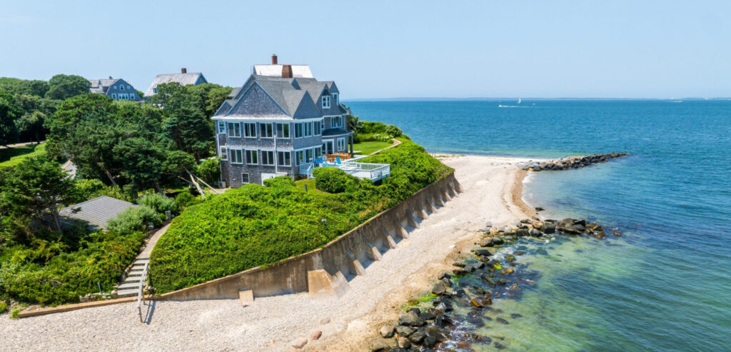 An wide shot of a waterfront property on Martha's Vineyard with a private beach.